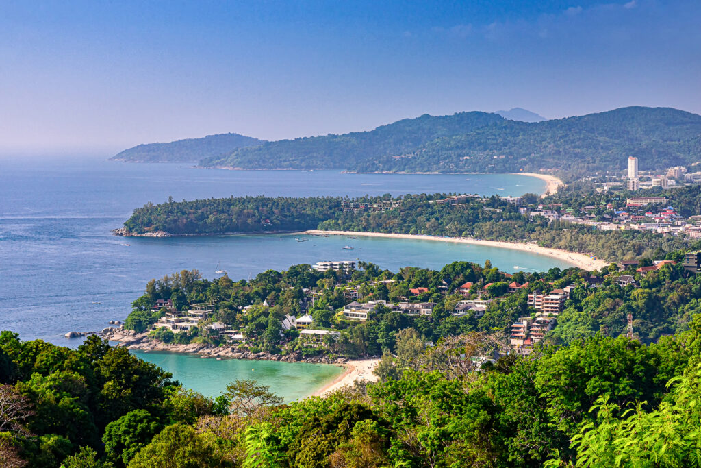 Scenic view of Kata and Karon beaches in Phuket, Thailand, showcasing lush green hills, clear blue waters, and luxury resorts. Bangkok Phuket krabi tour package. also showing best view to mitigate is thailand a safe country to travel confuision