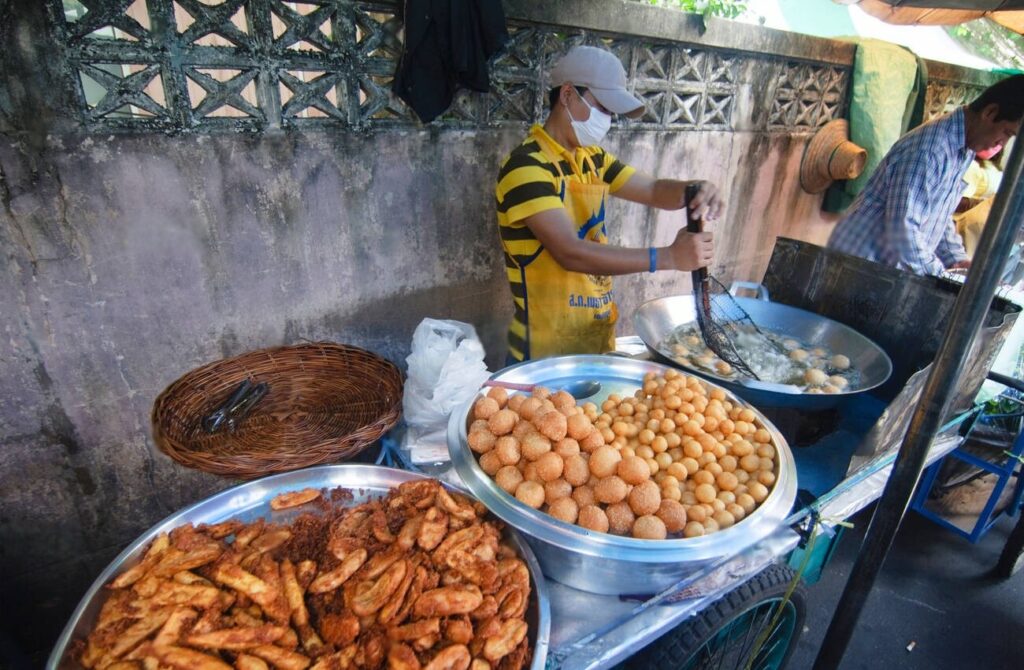 vendor selling street food in thailand