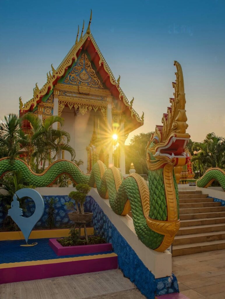 Beautiful Thai temple with colorful dragon sculpture at sunrise, a cultural highlight of the Thailand Package for Couple from Nepal.